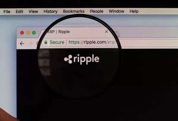 Magnifying glass over Ripple logo