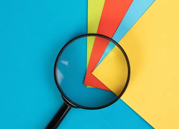 Magnifying glass with colorful sticky notes