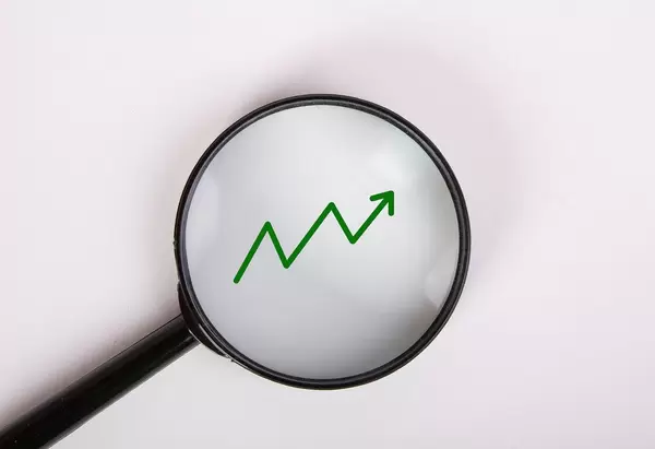 Magnifying glass with green chart