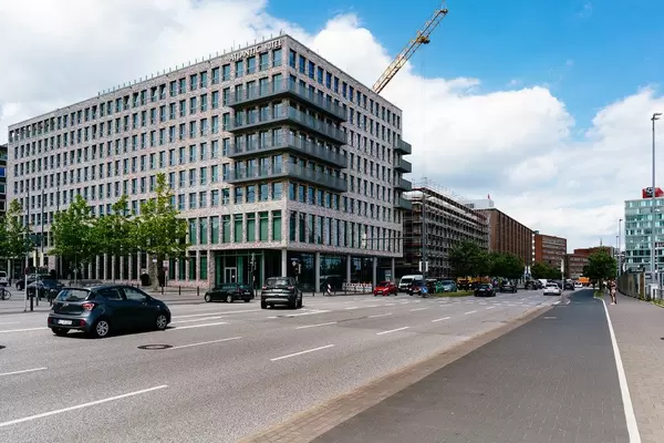 Main street in the city of Kiel with bike path and modern buildings