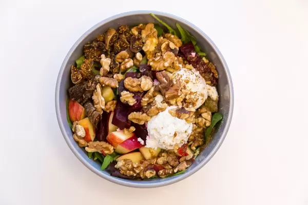 Make Food Top-view of Goatlovers Bowl with goat cheese, dried figs, apple, beetroot, walnuts, spinach salad, pick salad and raspberry maple dressing