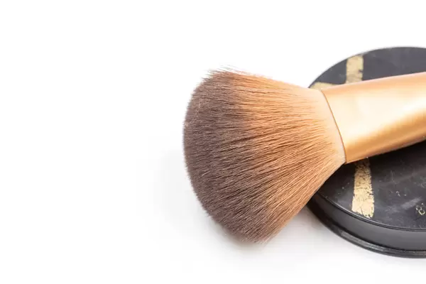 Makeup Brush with skin color Powder and copy space