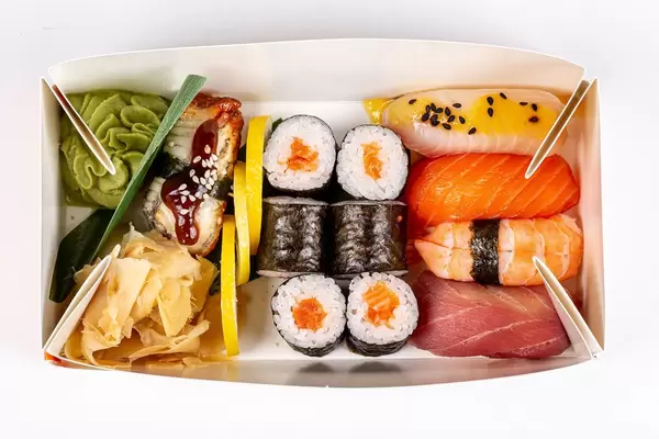 Maki rolls and nigiri in a cardboard box, top view