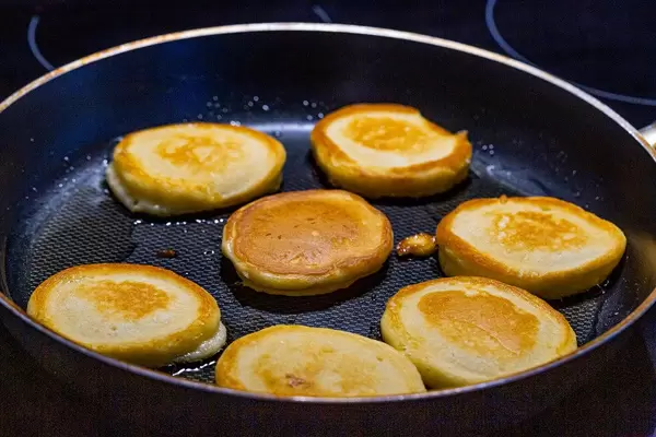 Making pancakes on frying pan