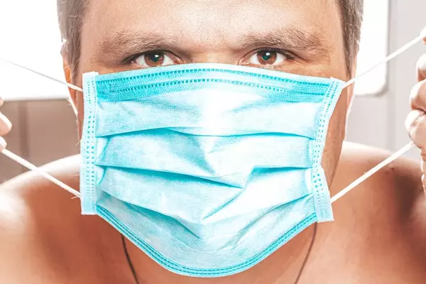 Male face with medical mask. The concept of prevention ill