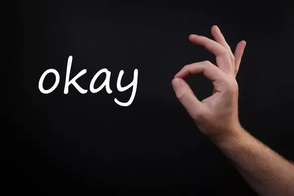 Male hand shows gesture OK