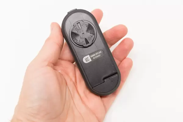 Male hand shows Varia RTL515 rearview radar and tail light from the back