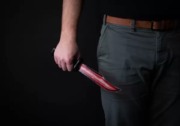 Male hand with bloody knife