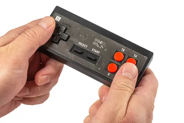Male hands are holding black joystick, game concept