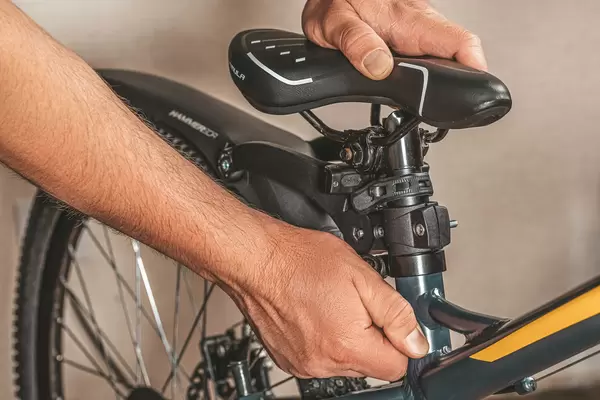 Male hands fixing the bike seat