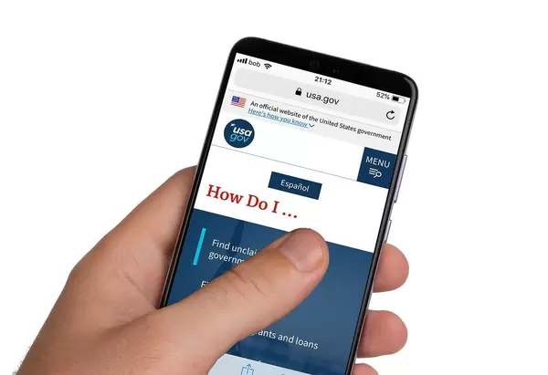 Male hands holding smartphone with an open website of the United States government