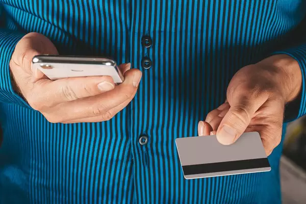 Male hands with card and smartphone, credit card payment concept