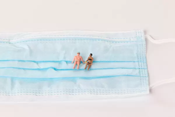 Man and woman in bath suit relaxing on medical face mask