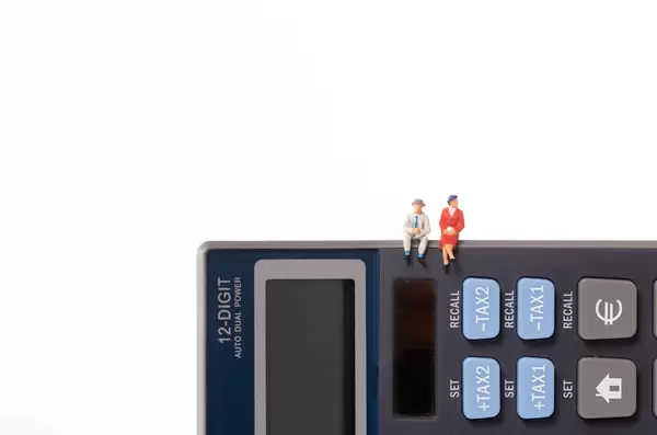 Man and woman sitting on calculator