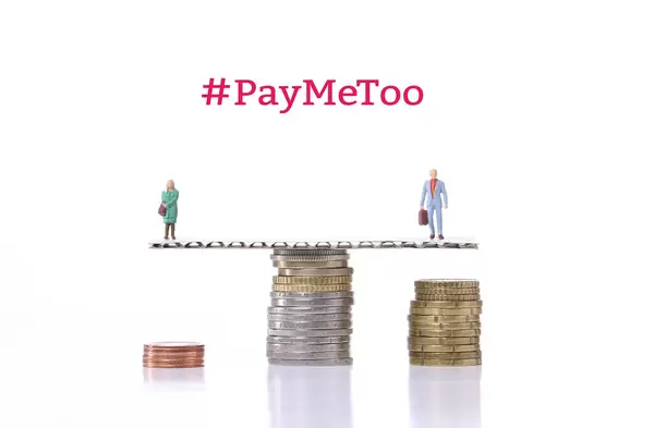 Man and woman standing on a scale with coin stacks and #PayMeToo text