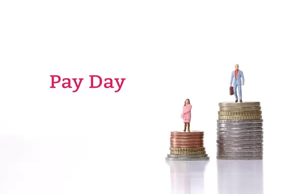 Man and woman standing on a stacks of coins with Pay Day text