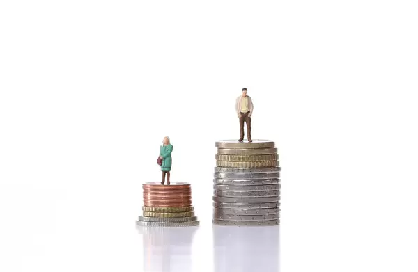 Man and woman standing on a stacks of coins