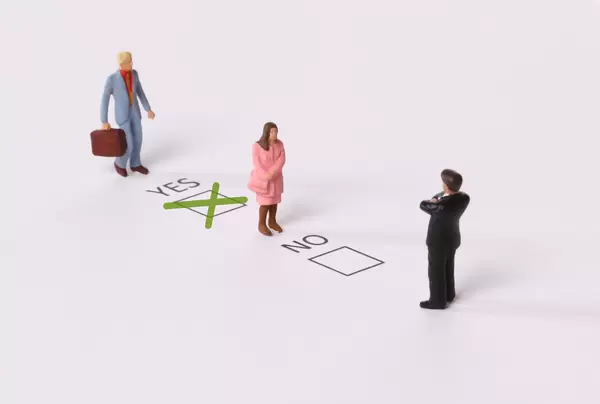 Man and Woman with Yes and No check boxes with green check mark in the Yes box