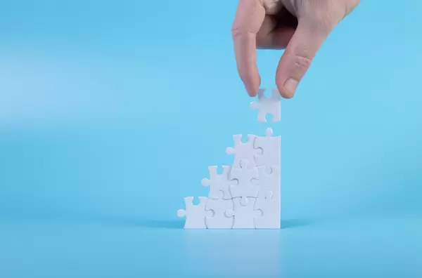 Man assembling a jigsaw puzzle