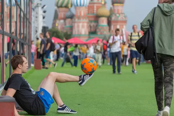 Man balancing a soccer ball on the very tip of his foot