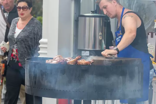 Man barbecuing turkey legs