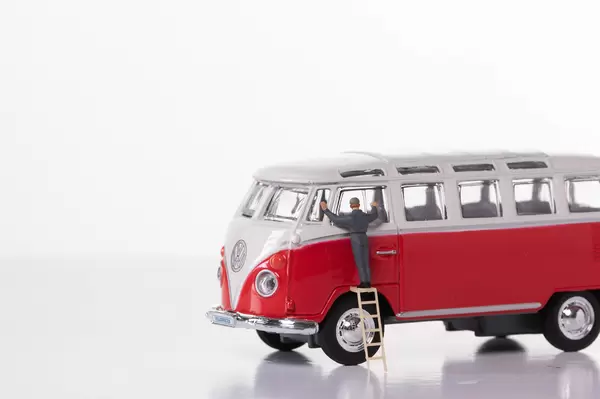 Man cleaning classic VW Camper van