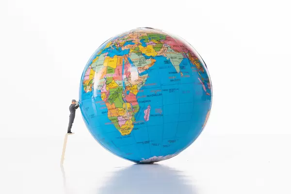 Man cleaning globe on white background