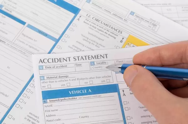 Man filling out accident statement report