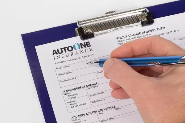 Man filling out car insurance policy