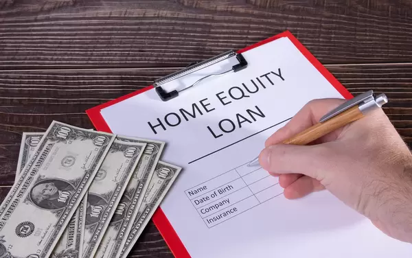 Man filling out Home equity loan document