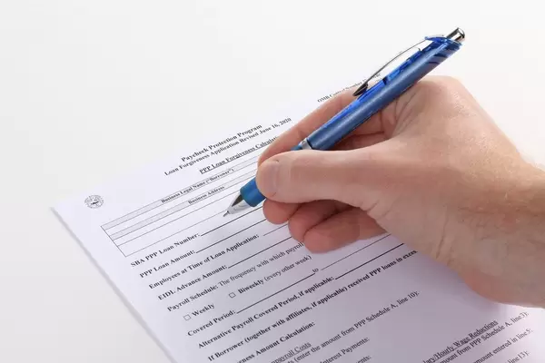 Man filling out Paycheck Protection Program Application