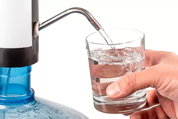 Man fills a glass with water
