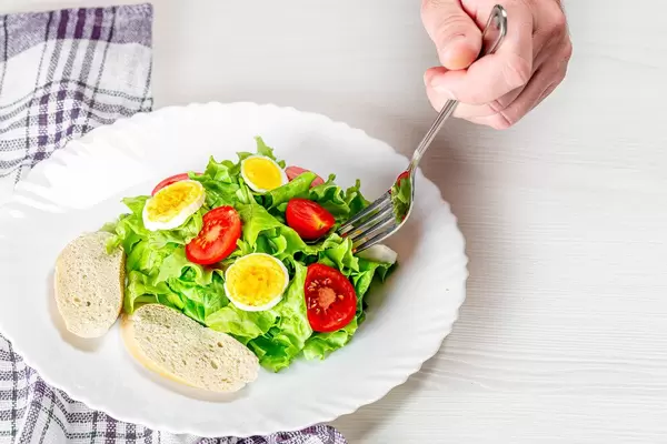 Man fork is gaining salad. The concept of diet (Flip 2019)