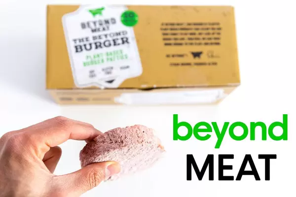 Man hand holds a frozen burger patty by beyond meat burger, infant of the ten pieces burger box package, for vegan, gluten free and soy free diet
