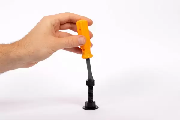Man hands with screwdriver and screw