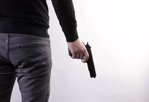 Man holding a gun in hand