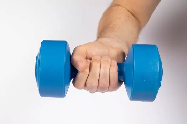 Man holding blue dumbbell isolated on white (Flip 2019)