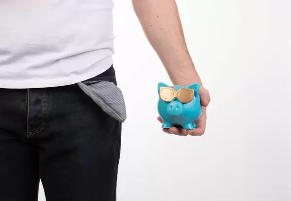 Man holding blue piggybank