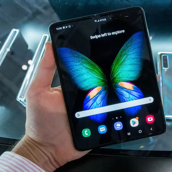 Man holding foldable smartphone Samsung's Galaxy 5G  with Infinity Flex display in his hand