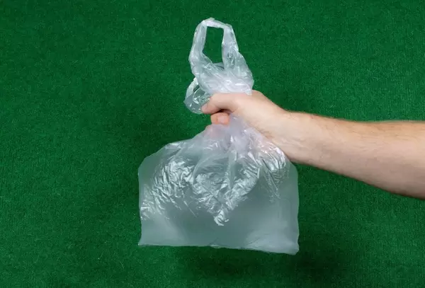 Man holding plastic shopping bag