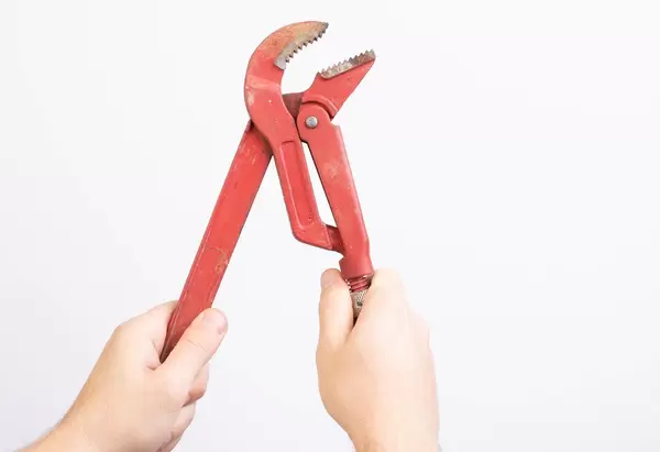 Man holding plumbers wrench