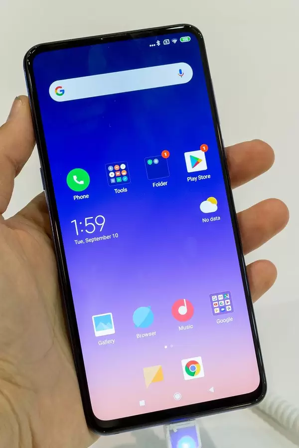 Man holds the MIX 3 5G Smartphone by Xiaomi in his hand