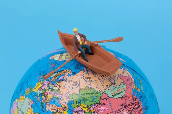 Man in a boat at top of the globe