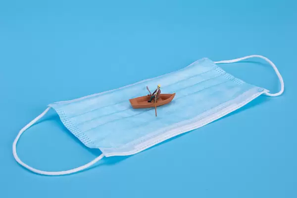 Man in a boat on medical face mask