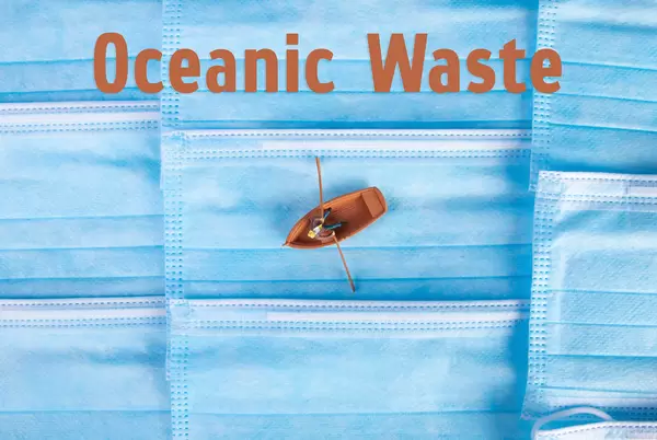 Man in a boat with face masks and Oceanic Waste text