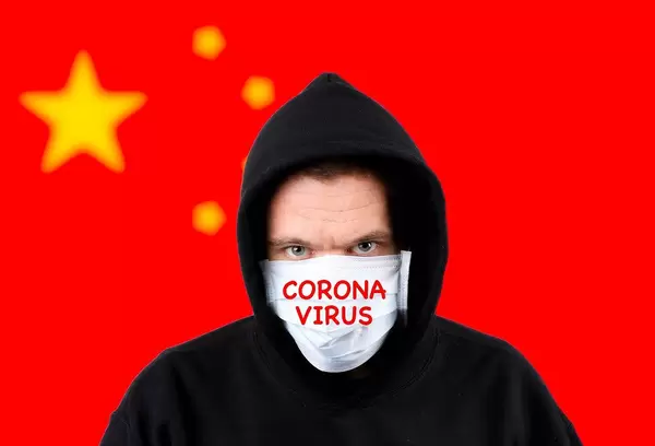 Man in hoodie wearing protection face mask with flag of China