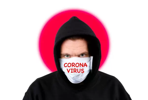 Man in hoodie wearing protection face mask with flag of Japan