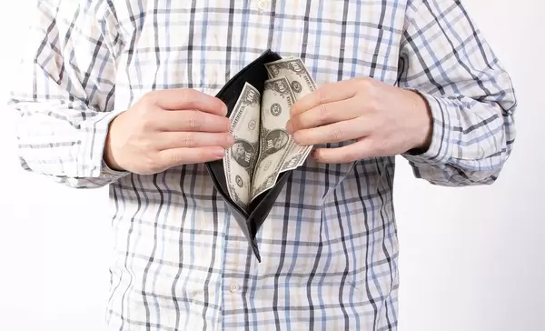 Man in shirt showing open wallet