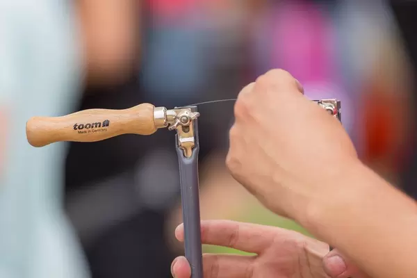 Man inserting a new saw blade into a fretsaw