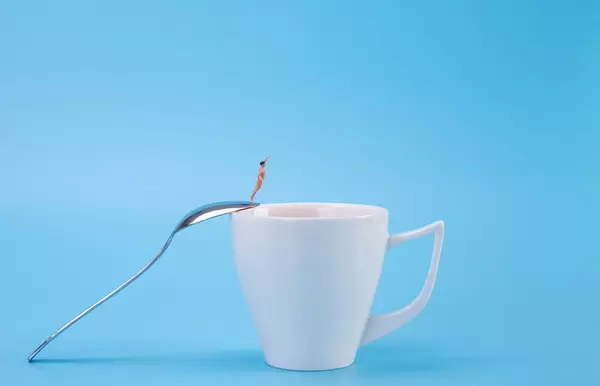 Man jumping into the coffee cup